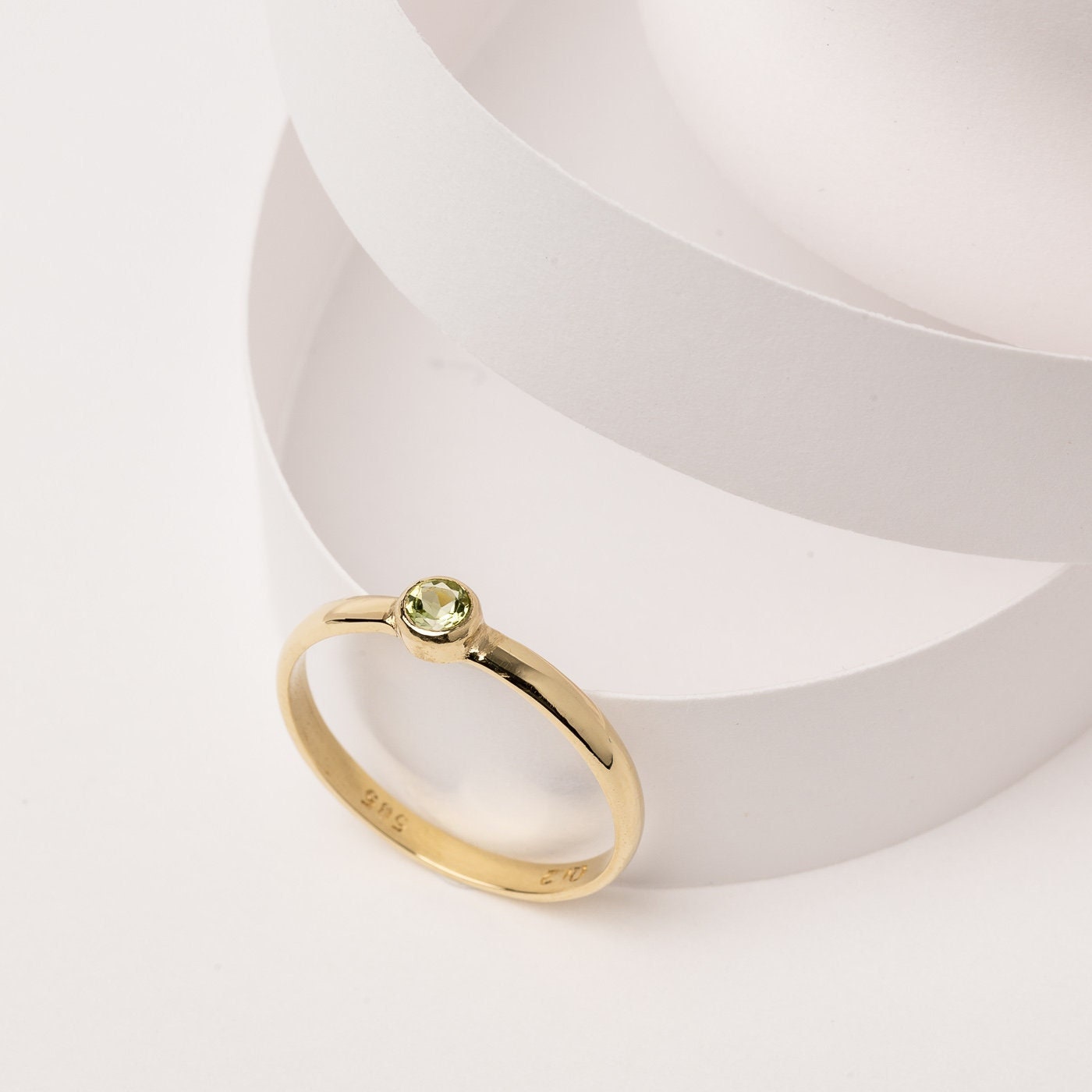 A handmade birthstone ring crafted in 14k solid gold, featuring a single stone in a bezel setting.