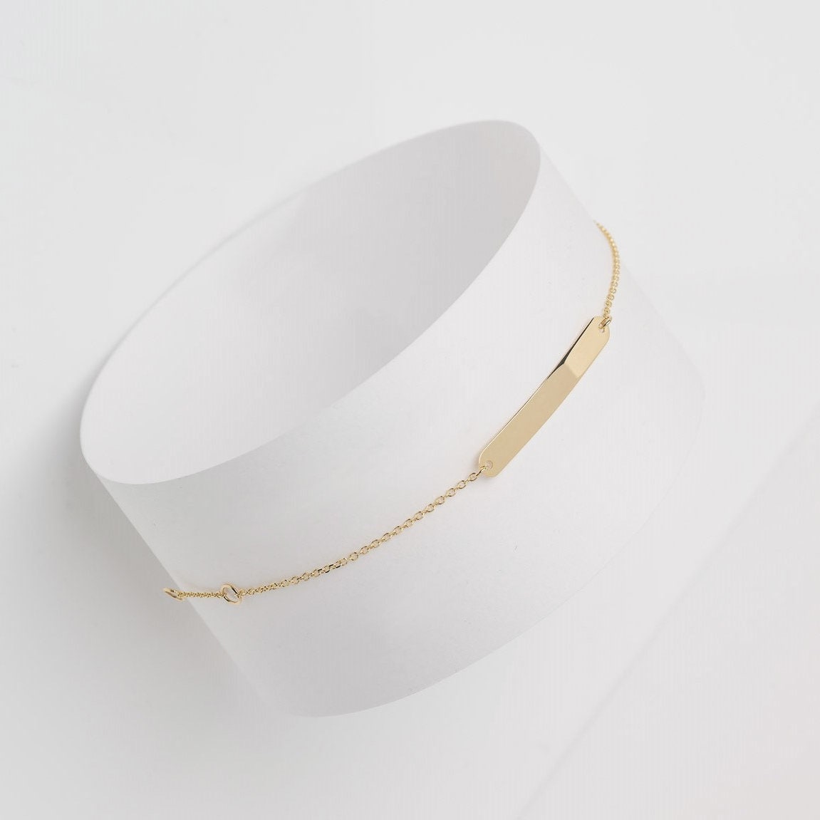 A delicate ID bracelet crafted in 14k gold, customizable for a personal touch.