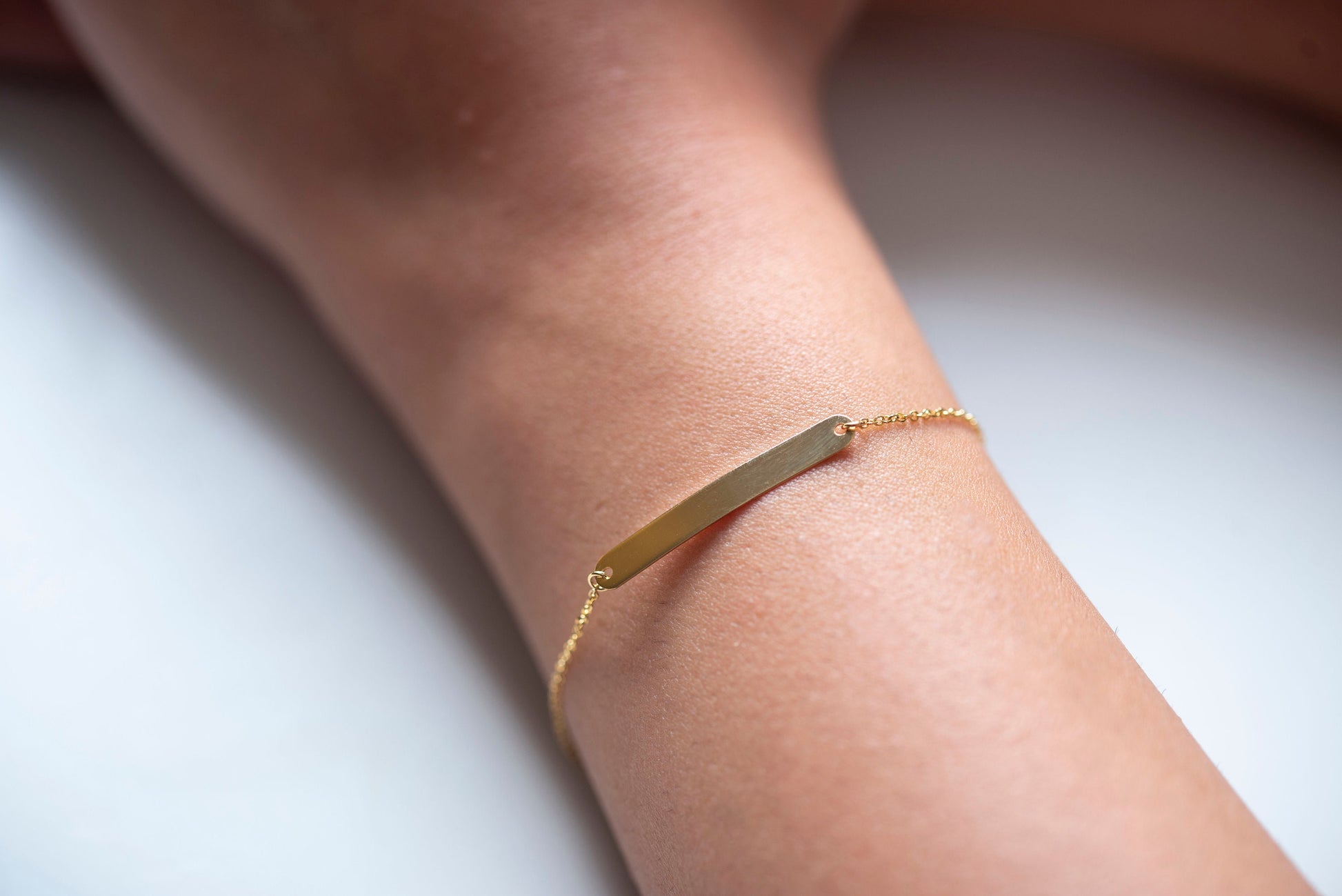 A delicate ID bracelet crafted in 14k gold, customizable for a personal touch.