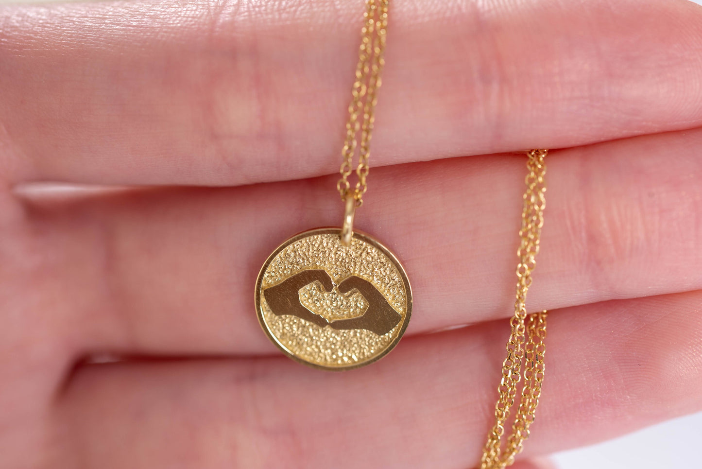 Hand Gesture Heart Necklace in 14k solid gold for women with free engraving on the back side.