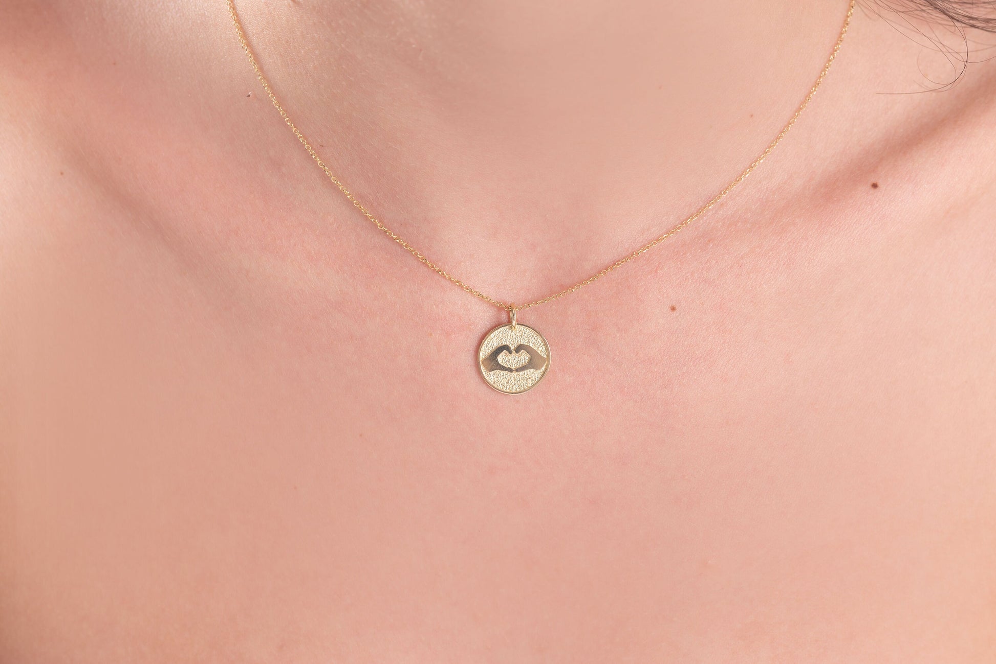 Hand Gesture Heart Necklace in 14k solid gold for women with free engraving on the back side.