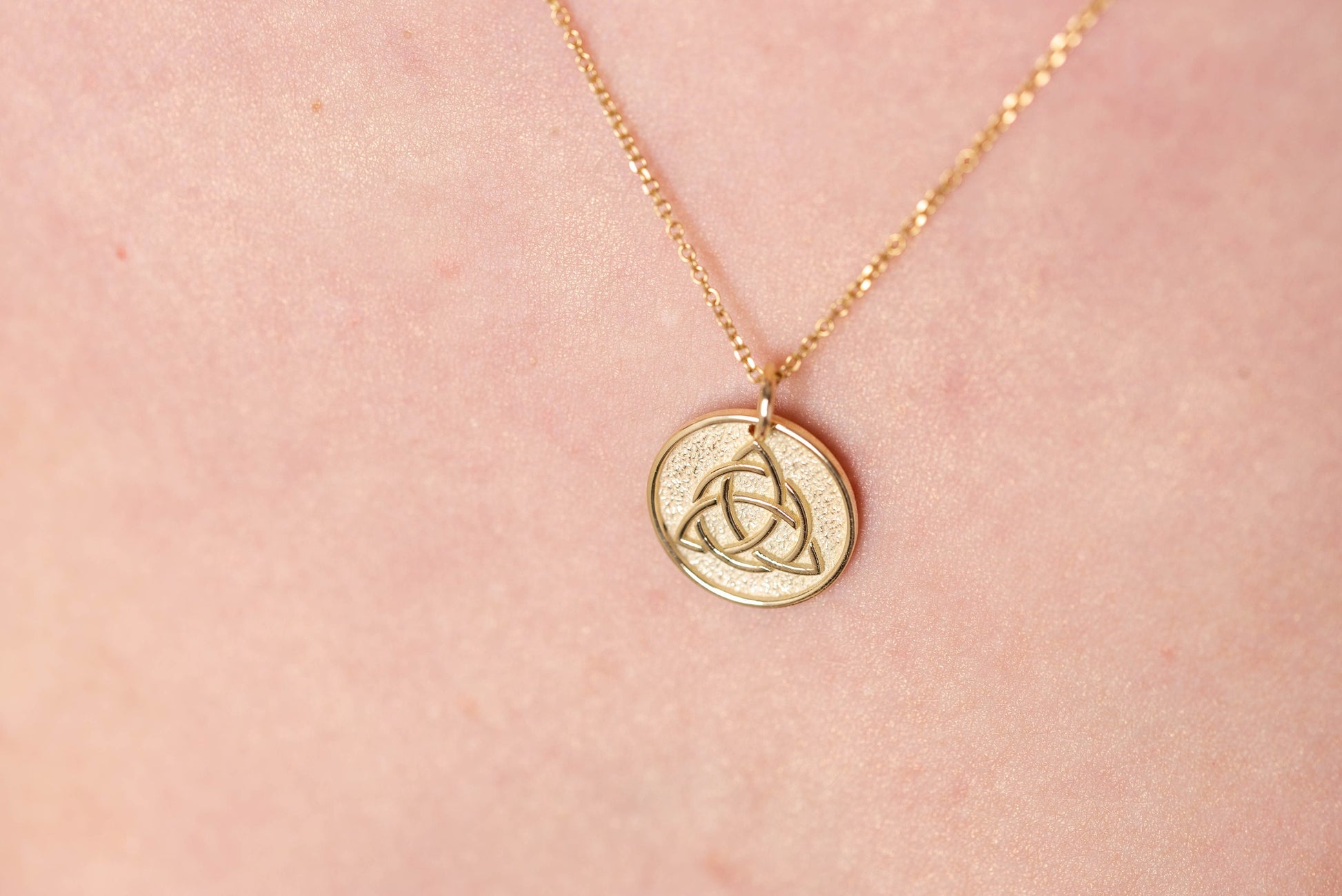 Trinity Knot Necklace in 14k solid gold for women, with complimentary engraving on the reverse side.