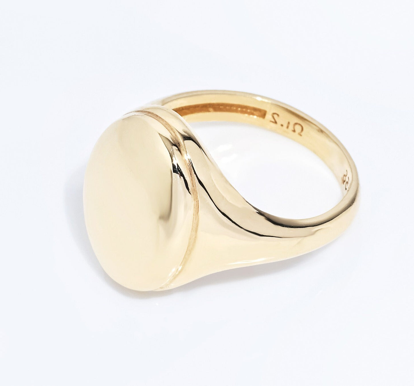 An Oval Signet Ring for women, crafted in 14k gold, featuring an engravable top surface.