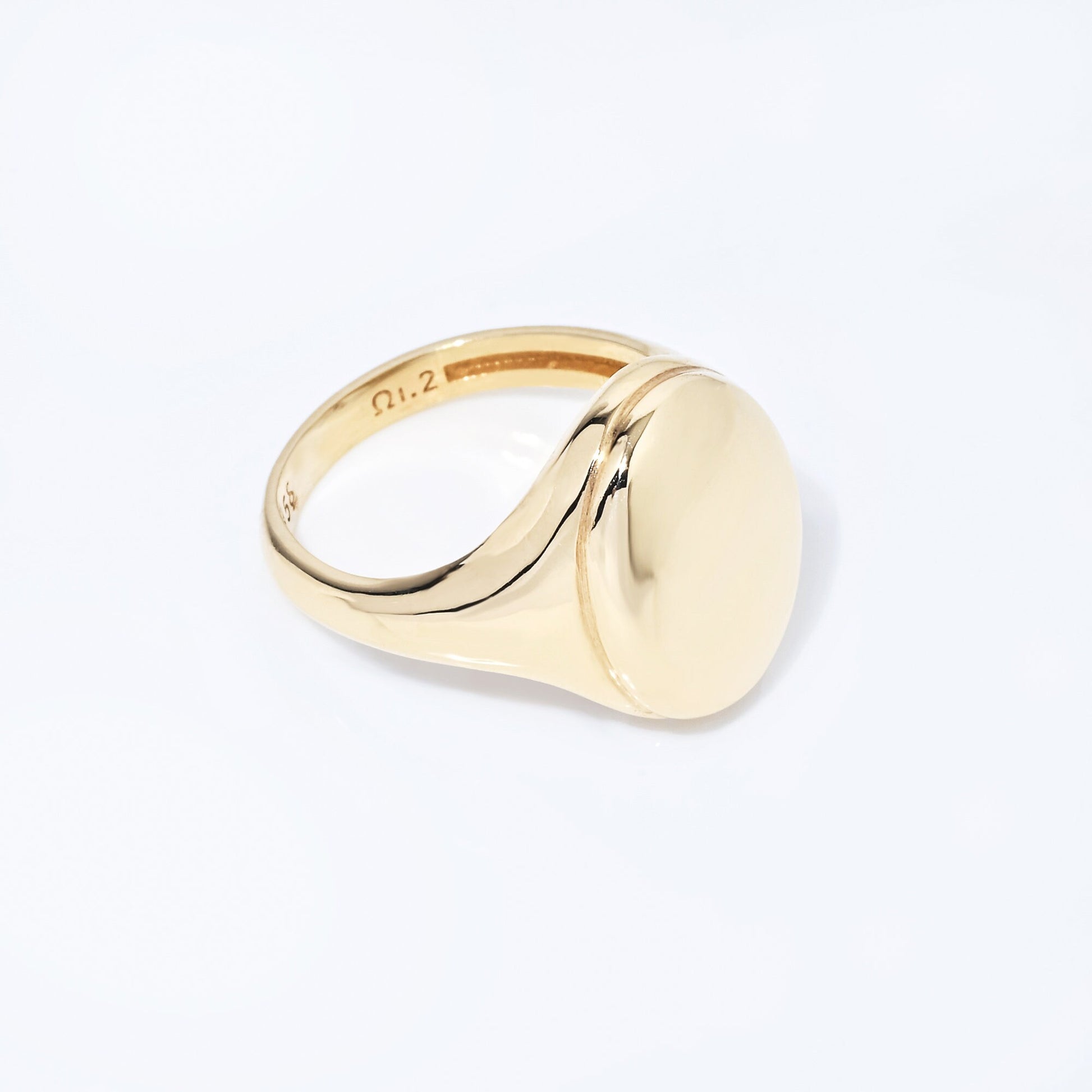 An Oval Signet Ring for women, crafted in 14k gold, featuring an engravable top surface.