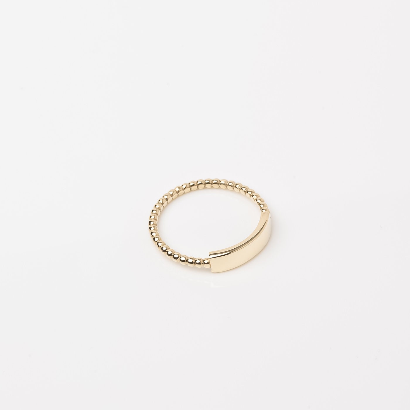 A personalized bar ring for women, crafted in 14k gold and featuring a beaded design.